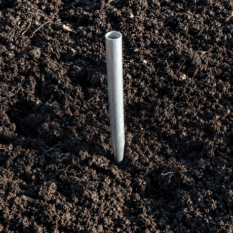 aluminium anchor for cage driven into dark soil