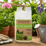 Garden naturally aphid spray concentrate bottle with gardening tools and plants in the background