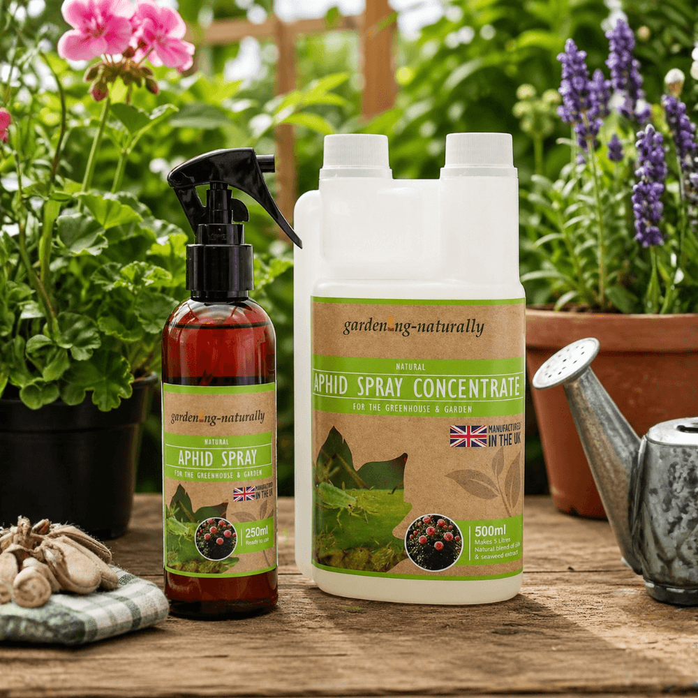 Garden spray bottles with labels on a wooden table with plants in the background