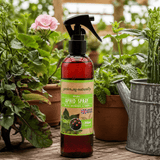 Bottle of aphid spray with plants in the background
