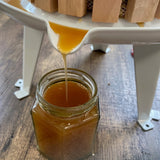 Homemade juice being poured from fruit press