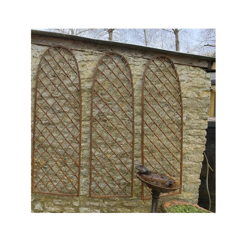 arched garden trellis on Cotswold stone wall