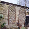 arched garden trellis on a wall in garden