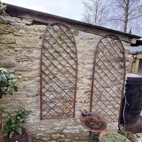 arched garden trellis on a wall in garden