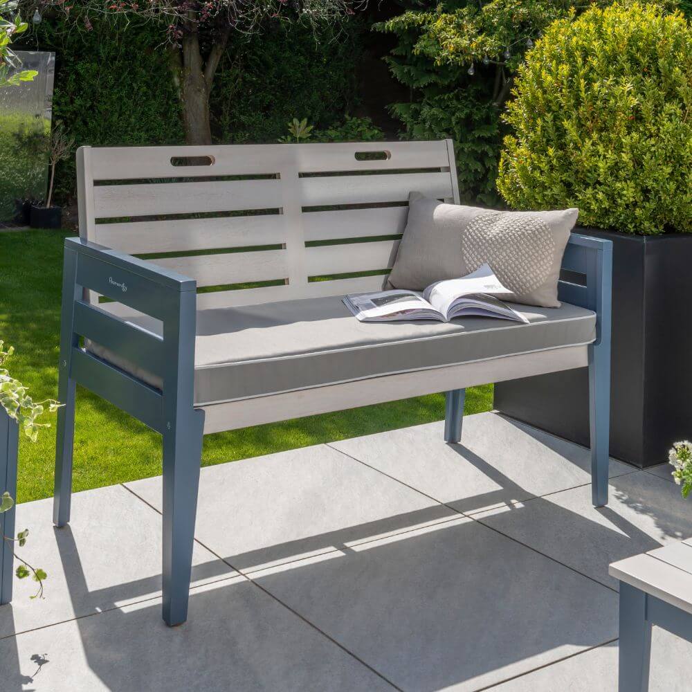 garden grey bench with cushion and book