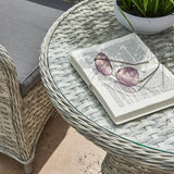 Close up of bistro table in garden with book and glasses on it