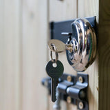 hanging silver circular padlock from black bolt lock on wooden garden storage box