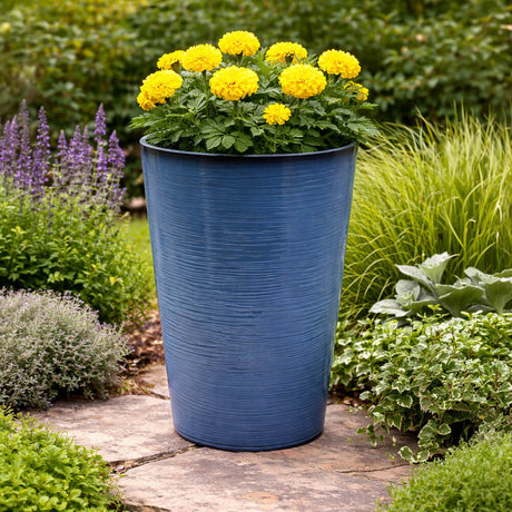 Blue planter with yellow flowers in a garden setting
