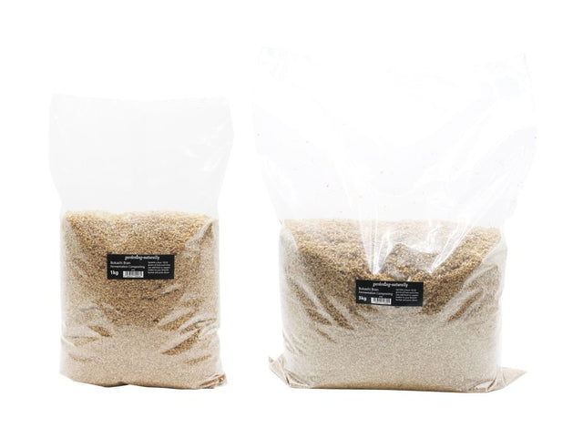 Two transparent plastic bags, one labeled as 1kg and the other as 2kg, containing  Bokashi Bran for composting.