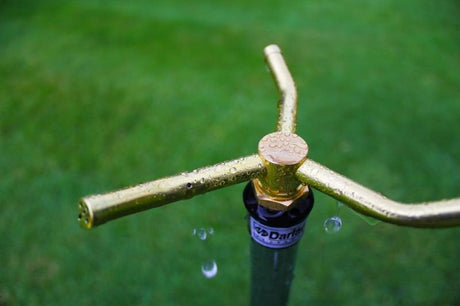 Brass 3 arm sprinkler in use on lawn