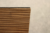 Close-up of the textured ribbed finish on a brown square plant pot
