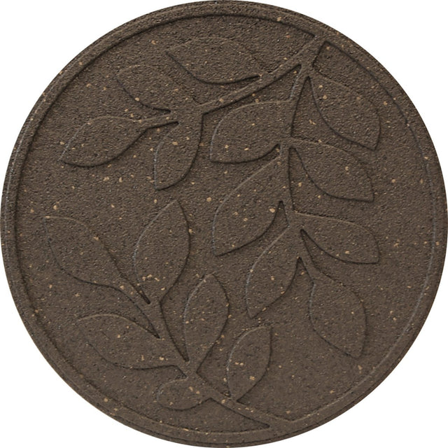 A circular brown stepping stone with a large imprinted leaf design in the center.