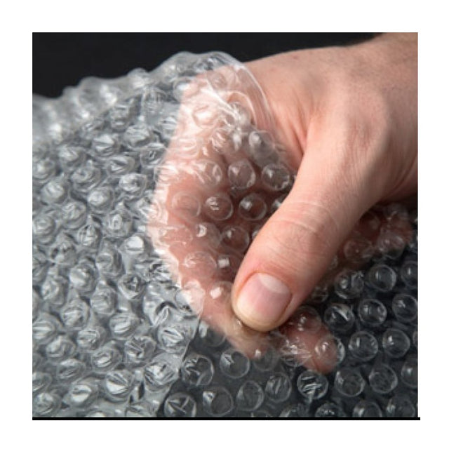 A hand holding a piece of clear bubble wrap typically used for packaging and insulation.