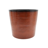dark orange cylindrical pot with ribbed texture on a white background