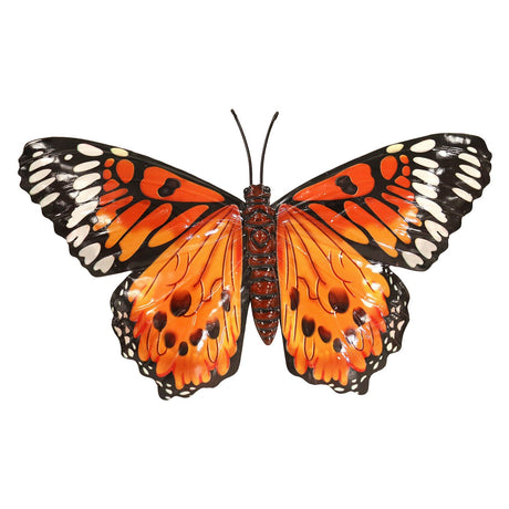 Single orange butterfly on a white wall garden decoration
