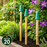 Three bamboo stakes with green caps in a garden setting with purple flowers and green plants.