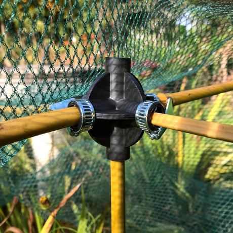 cane connector shown connecting bamboo canes with garden netting on top