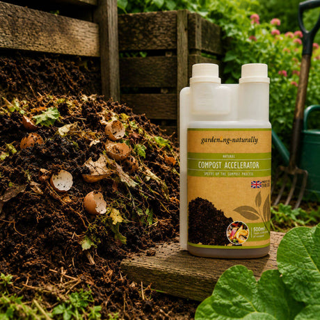 Compost accelerator bottle labeled 'garden.ng.naturally' next to a compost pile in a garden setting.