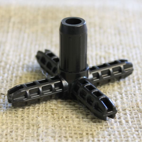 A black metal cross-shaped cage connector joiner