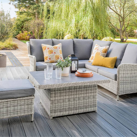Garden furniture on decking in garden with cushions 