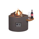 A cylindrical fire pit with a glass bottle and a bottle of wine, creating a cozy ambiance for outdoor gatherings.