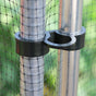 A fruit cage door catch clip attached to a metal cage upright post, with a mesh fabric attached to the cage.