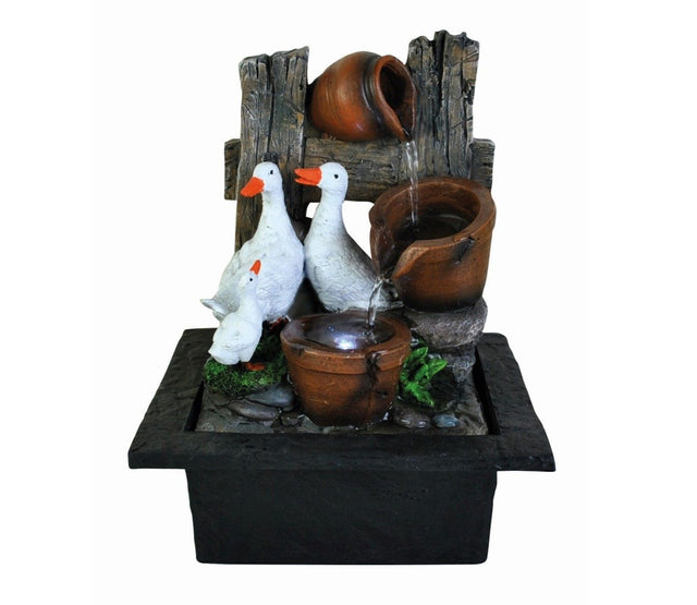 Indoor table top water feature depicting two ducks by a water bowl with a LED light, set against a farmyard style background.
