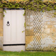 expanding willow trellis on garden wall