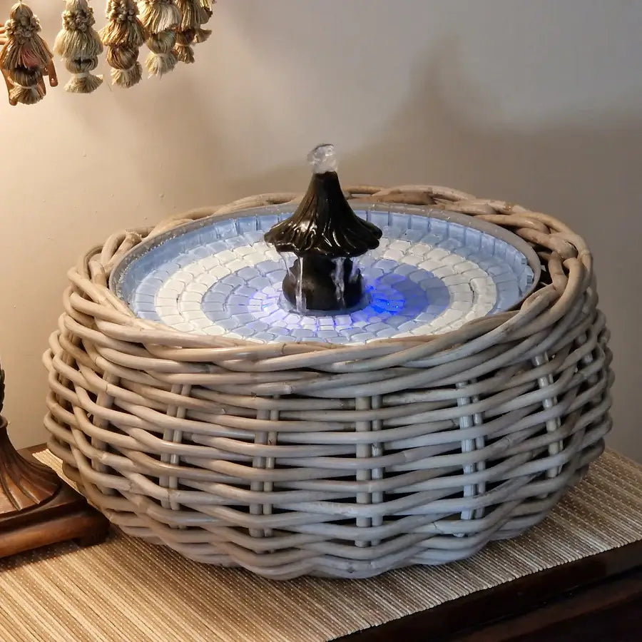Decorative table fountain with wicker base 