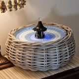 Decorative table fountain with wicker base 