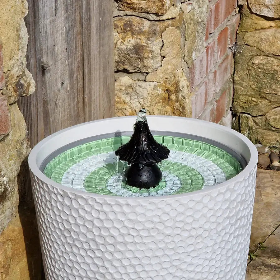 Water fountain in white pot