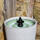 Water fountain in white pot