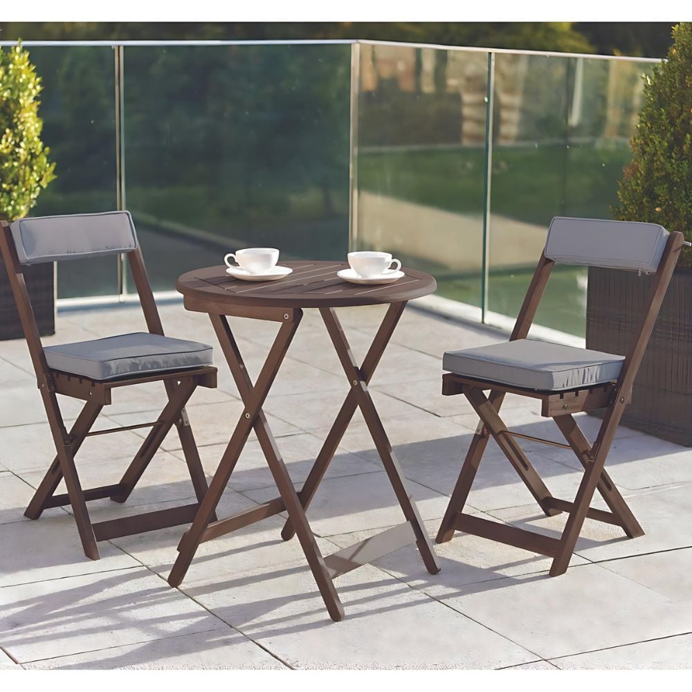 Patio furniture set featuring a table and two chairs on a balcony