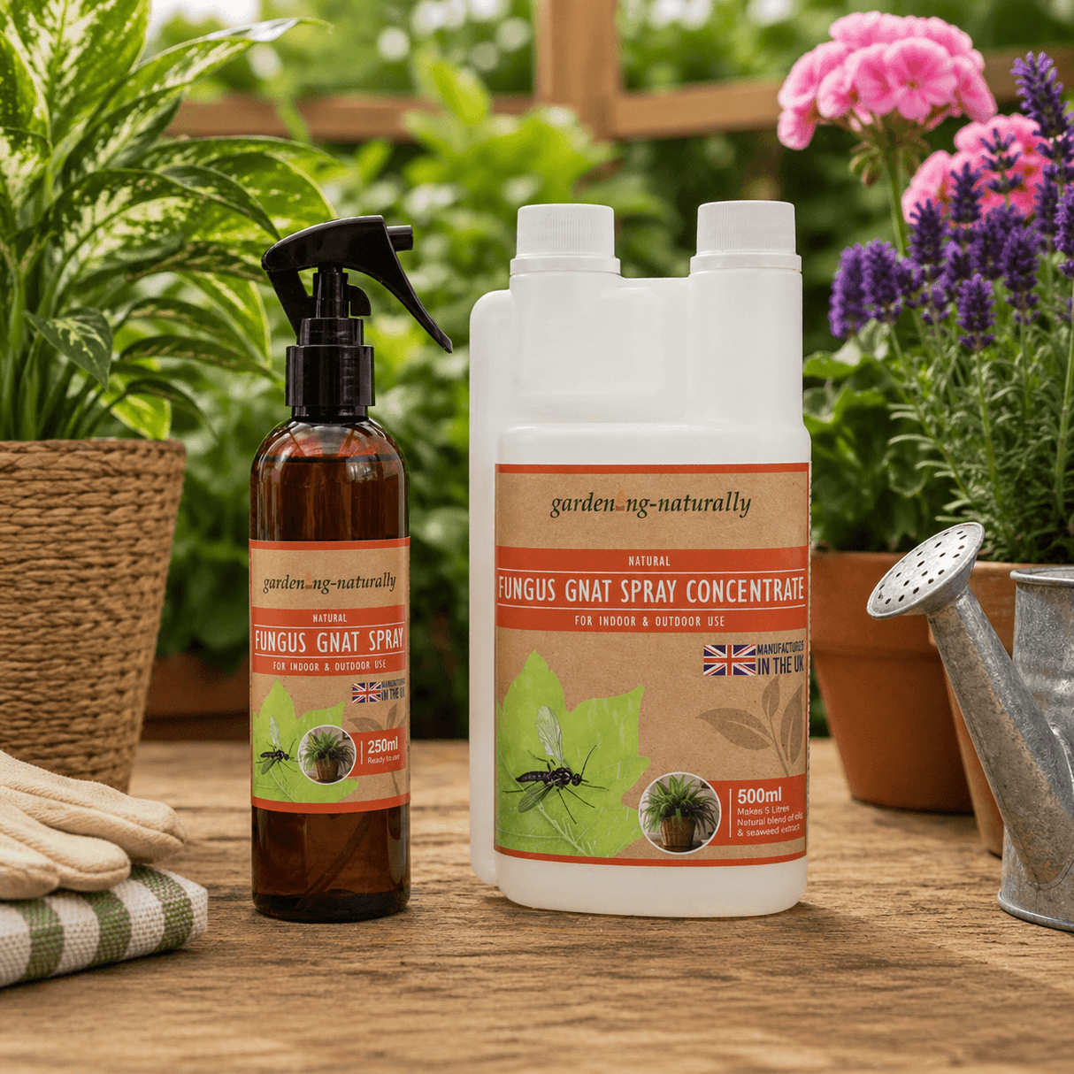 Garden care products including a spray bottle and concentrate bottle on a wooden surface with plants in the background.