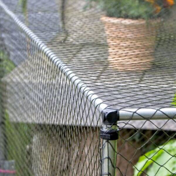 corner of garden cage showing components and netting
