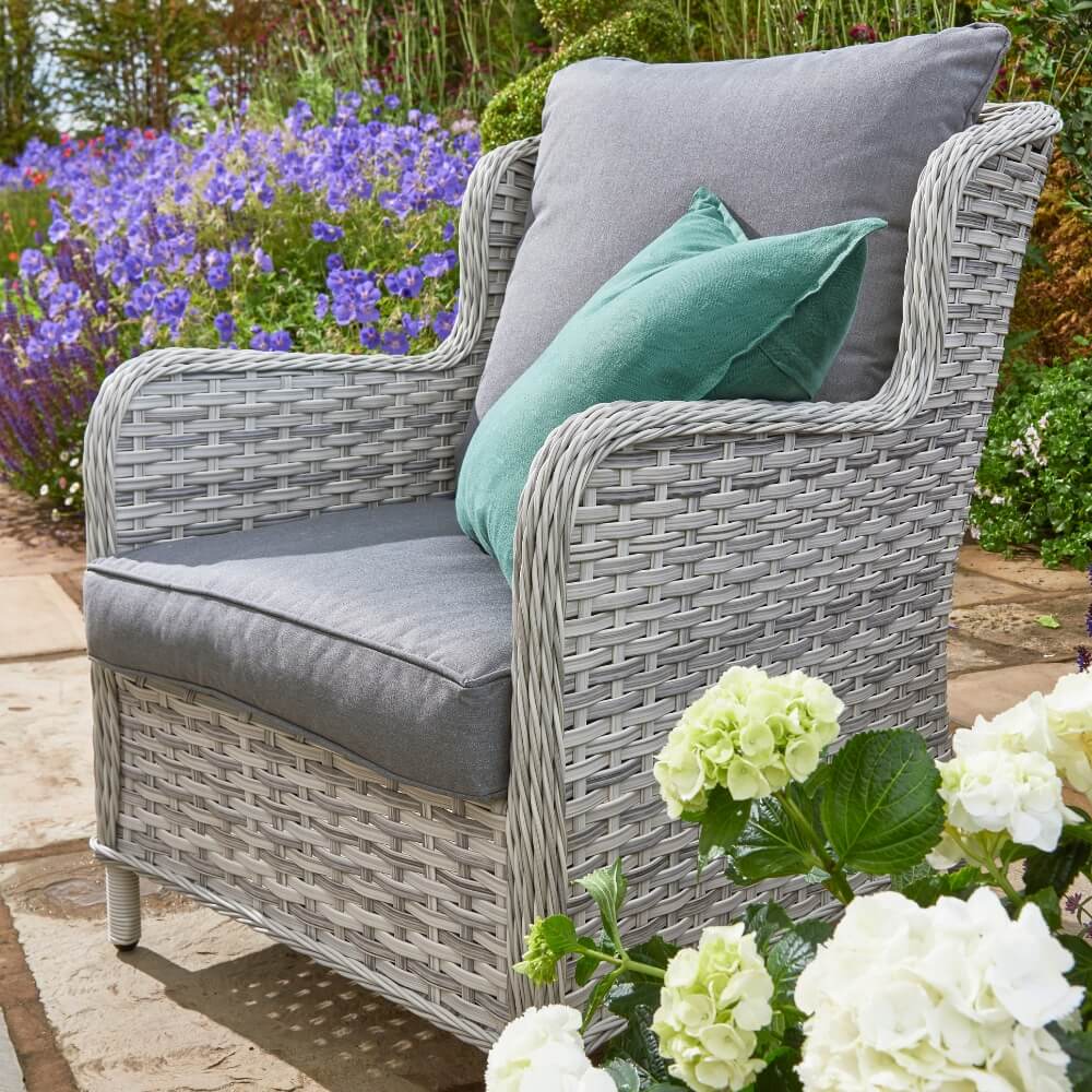 Rattan chair in garden with cushions