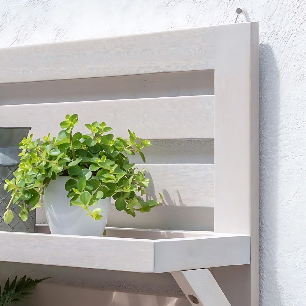 garden shelf on wall with plant pots on in garden