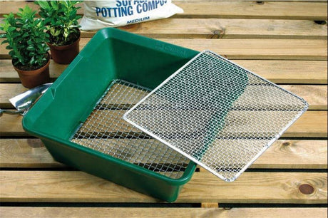 garden sieve in green on a table