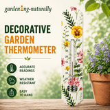 Decorative garden thermometer with floral design on a blurred garden background