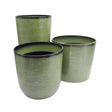 Three green ceramic planters with ribbed texture on a white background