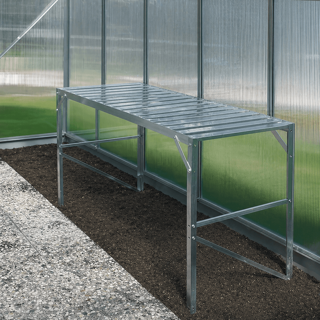 Metal greenhouse frame against a glass wall in a greenhouse setting