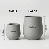 Two gray concrete planters, one small and one large, with measurements indicated on a white background.