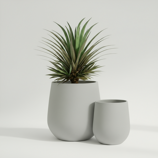 Two grey plant pots with a plant on a wooden floor in a living room setting.
