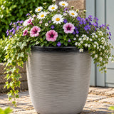 Grey pot with flowers outside