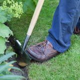 RHS Stainless Steel Half Moon Lawn Edger being used to tidy lawn edge