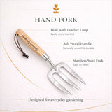 Hand fork with ash wood handle and stainless steel prongs on a white background