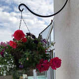 Hanging basket bracket with hanging basket full of flowers