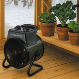 Black garden heater 
on a wooden deck with potted plants in the background