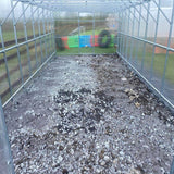 inside of a greenhouse with gravel on the floor