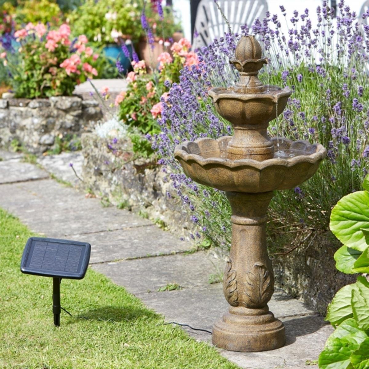 water fountain in pretty garden sat on a path
